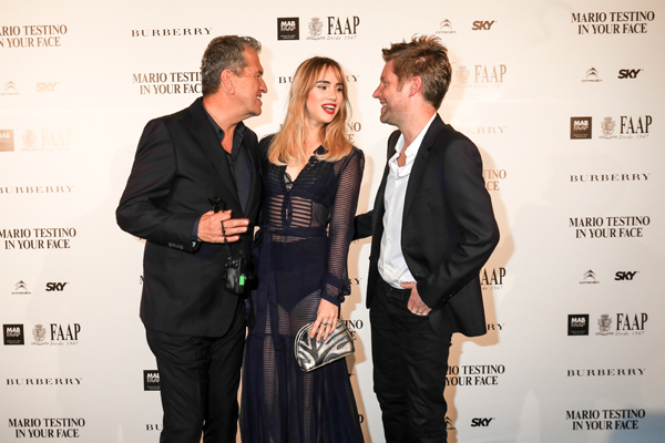 Mario Testino, Suki Waterhouse & Christopher Bailey wearing Burberry at the Mario Testino `In Your Face' exhibition opening event in Brazil.